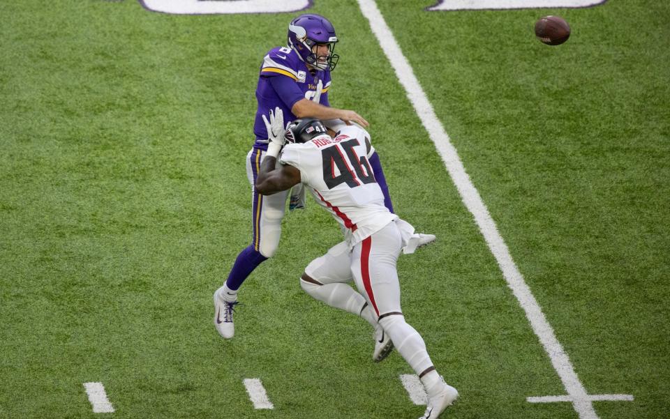 Minnesota Vikings quarterback Kirk Cousins (8) is hit, forcing an incomplete pass, by Atlanta Falcons linebacker Edmond Robinson (46) in the first quarter of an NFL football game in Minneapolis, Sunday, Oct. 18, 2020. - AP