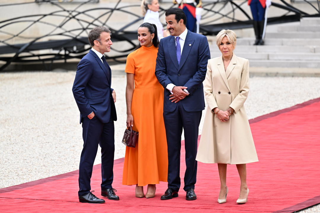 PARIS, FRANCE - JULY 26: France's President Emmanuel Macron and his wife Brigitte Macron greet Qatari Emir Sheikh Tamim bin Hamad Al Thani on arrival ahead of a reception for heads of state and governments ahead of the opening ceremony of the Paris 2024 Olympic Games, at the Elysee presidential palace in Paris, on July 26, 2024. (Photo by Mustafa Yalcin/Anadolu via Getty Images)