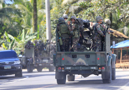 Military vehicles carrying government troops drive along a main highway of Pantar town, Lanao Del Norte, as they travel to reinforce Marawi city, southern Philippines May 24, 2017. REUTERS/Romeo Ranoco