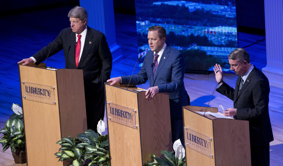 Republican gubernatorial candidate Ed Gillespie, right, gestures as Corey Stewart, center, and State Sen. Frank Wagner, left, listens during a debate at Liberty University in Lynchburg, Va., Thursday, April 13, 2017. (AP Photo/Steve Helber)