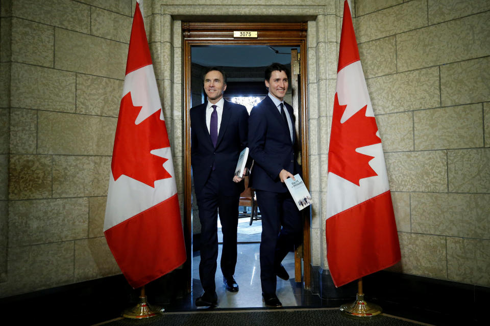 Canada's Prime Minister Justin Trudeau and Finance Minister Bill Morneau walk from Trudeau's office to the House of Commons to deliver the budget on Parliament Hill in Ottawa, Ontario, Canada, February 27, 2018. REUTERS/Chris Wattie