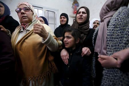 Relatives of Palestinian youth Omar Madi, who was shot and killed by Israeli troops on Wednesday, mourn during his funeral in Arroub refugee camp, north of the West Bank city of Hebron, February 11, 2016. REUTERS/Mussa Qawasma