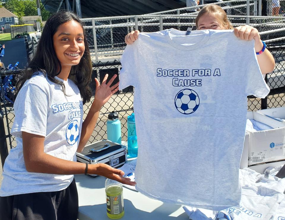 Soccer for a Cause Charity Festival participants display T-shirts during last year's event.