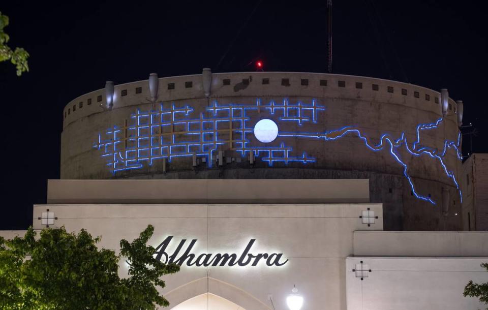 Michael Bishop’s art, a representation of the circular water tower surrounded by the Sacramento street grid and winding river and delta, lights up blue at night on the side of the immense concrete water tower behind the Alhambra Safeway, known as the Alhambra Reservoir. Xavier Mascareñas/xmascarenas@sacbee.com