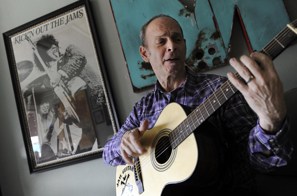 In this Jan. 16, 2012 photo, guitarist Wayne Kramer, founder of the band the MC5, plays one of the instruments that will be provided to jail inmates as part of the Jail Guitar Doors USA initiative at his recording studio in Los Angeles. The Jail Guitar Doors program provides instruments to inmates who are using music as a means of achieving rehabilitation. (AP Photo/Chris Pizzello)