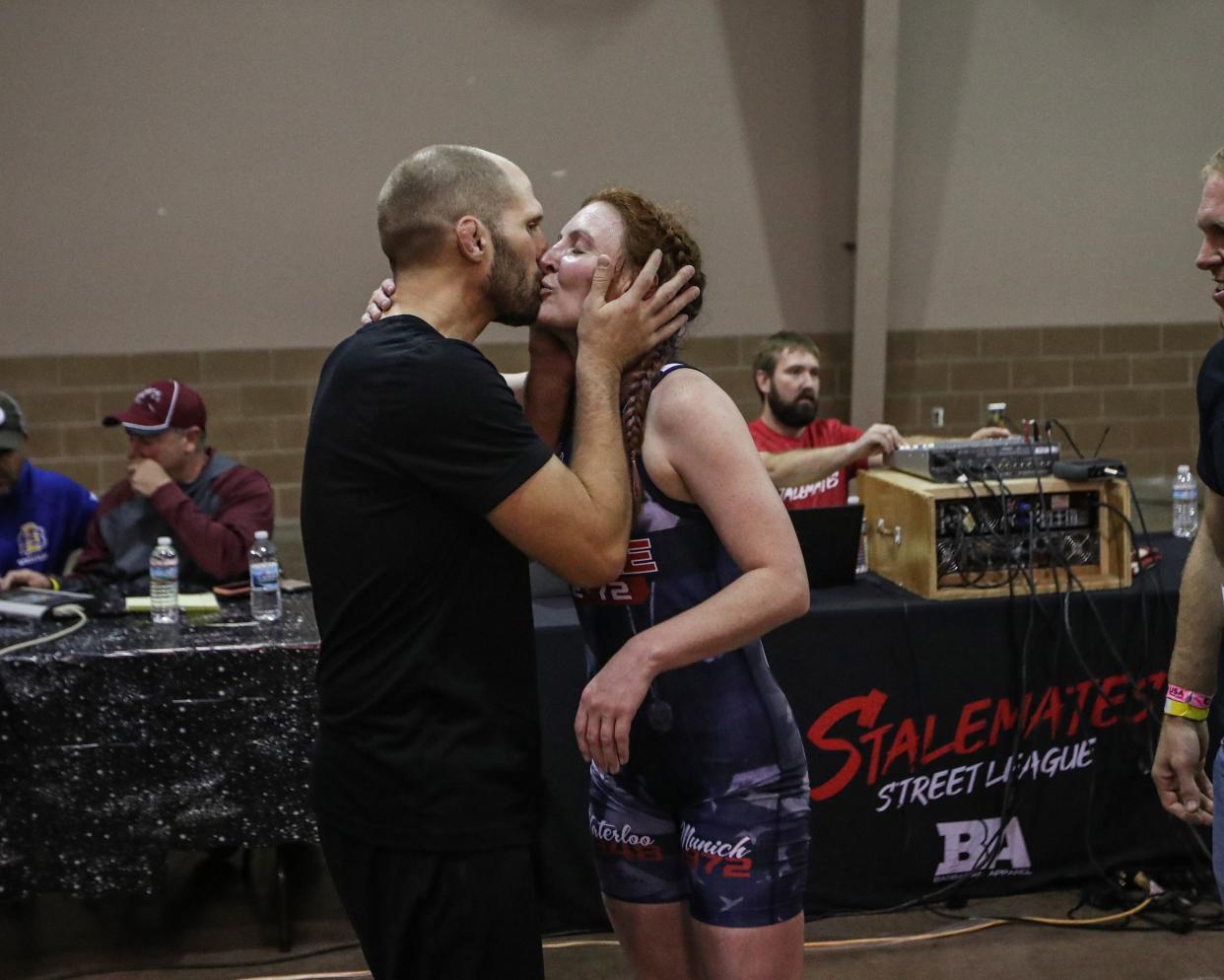 Becca Roper's coach and husband, Lee Roper, shows his appreciation for her efforts in her first career match on Friday, Oct. 29, 2021, at the StaleMates II competition at the Elwell Family Food Center at the Iowa State Fairgrounds, Des Moines.