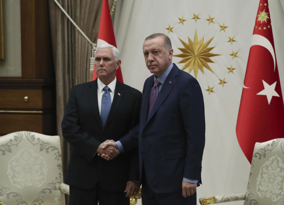 Turkey's President Recep Tayyip Erdogan, right, shakes hands with U.S Vice President Mike Pence, prior to their talks at the Presidential Palace in Ankara, Turkey, Thursday, Oct. 17, 2019. A high level U.S. delegation arrived in Turkey on Thursday for talks on a cease-fire in Syria. (Presidential Press Service via AP, Pool)