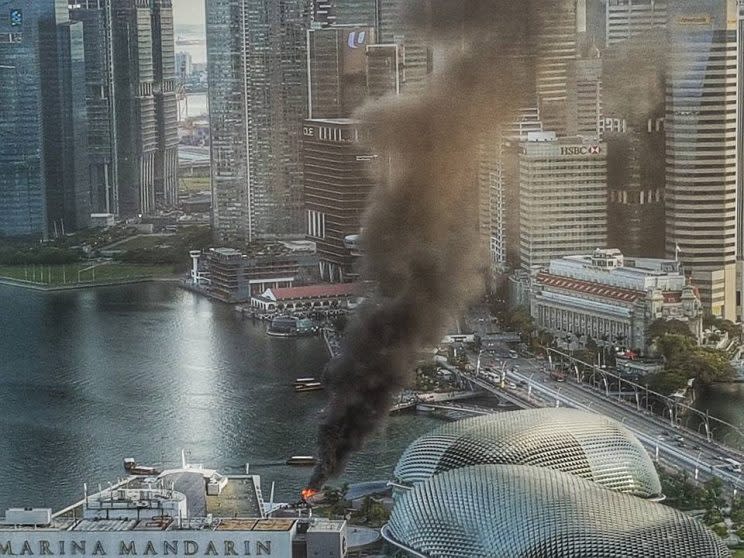 Smoke coming out from the bumboat after it caught fire near the Esplanade. (PHOTO: Lim Wui-Liang)