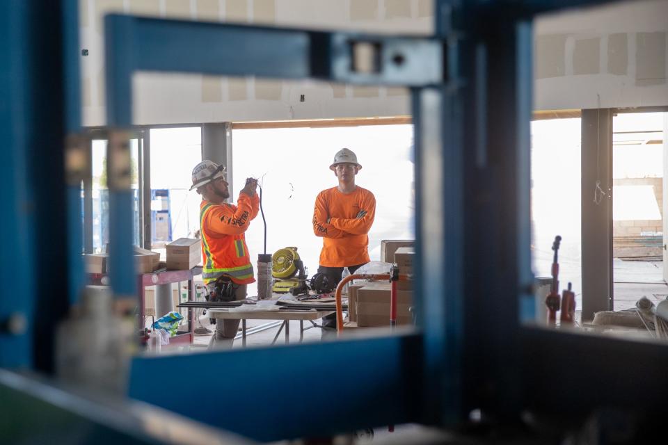 Construction workers inside the new DraftKings Sportsbook, which is under construction at TPC Scottsdale on Aug. 16, 2023.
