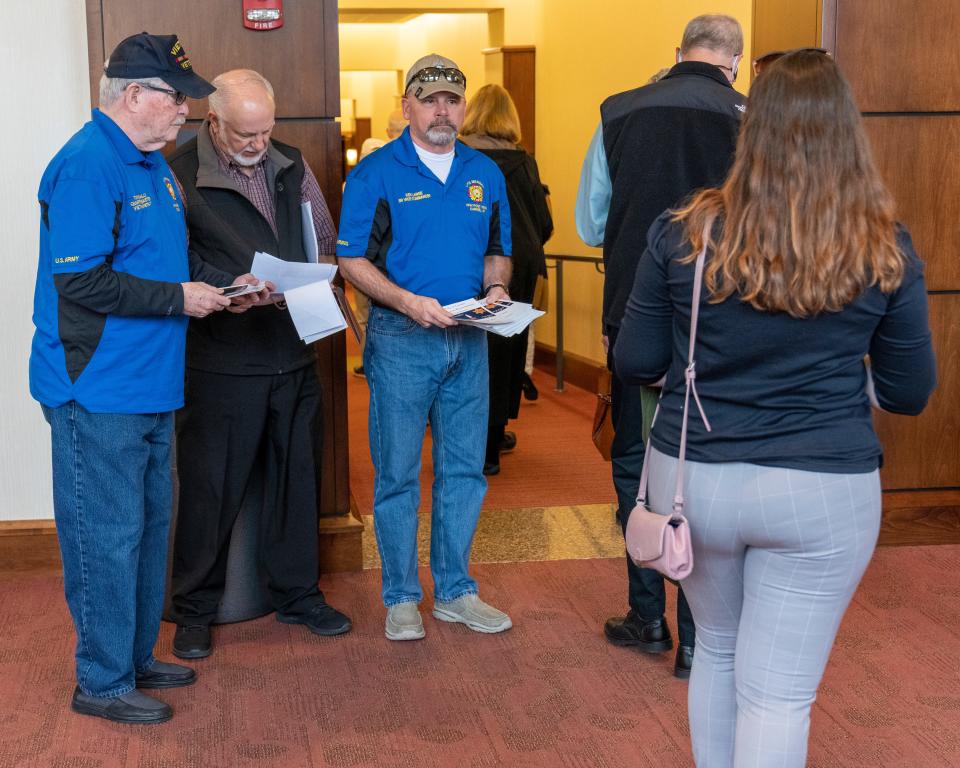 VFW members hand out programs Friday, April 29, 2022, at a Holocaust remembrance ceremony at the Tarkington Theater in Carmel. 