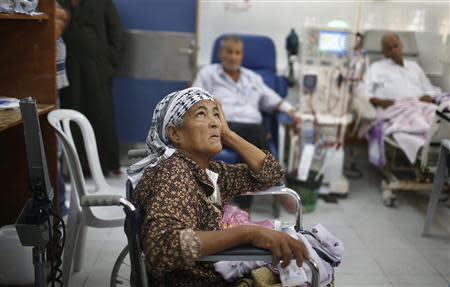 A wheelchair-bound Palestinian woman waits to undergo kidney dialysis at al-Shifa hospital in Gaza City September 12, 2013. REUTERS/Suhaib Salem