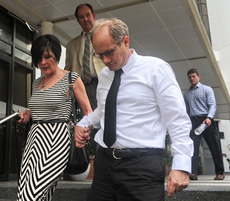 Rick Todd (right) and his wife Mary walk out of the Subordinate courts in Singapore on Tuesday. Their walk out came after their star witness, a US pathologist who never examined the body, came under intense questioning for saying Shane Todd may have been killed by assassins after quitting a high-tech project for two Asian firms