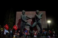People sit in front of a statue as they gather in solidarity night after night since the July 15 coup attempt in central Ankara, Turkey, July 27, 2016. REUTERS/Umit Bektas