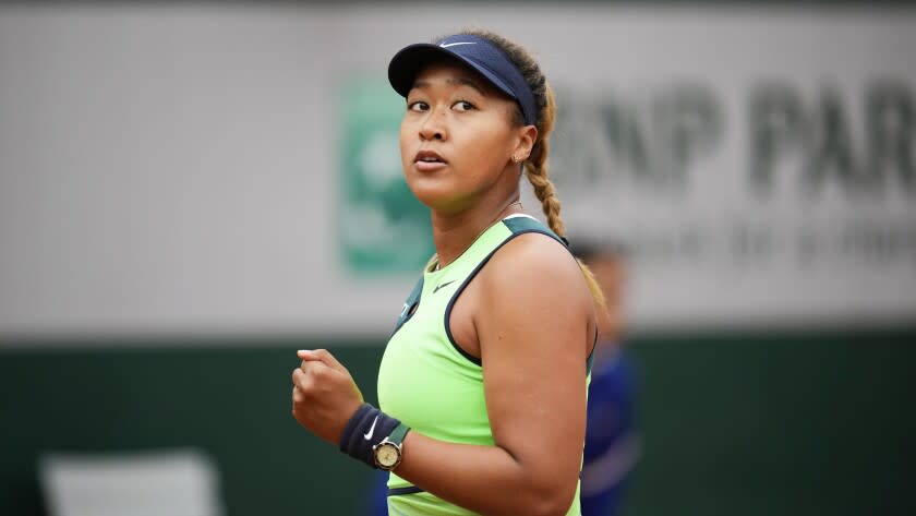 Japan's Naomi Osaka clenches her fist after scoring a point against Amanda Anisimova of the U.S. during their first round match at the French Open tennis tournament in Roland Garros stadium in Paris, France, Monday, May 23, 2022. (AP Photo/Christophe Ena)