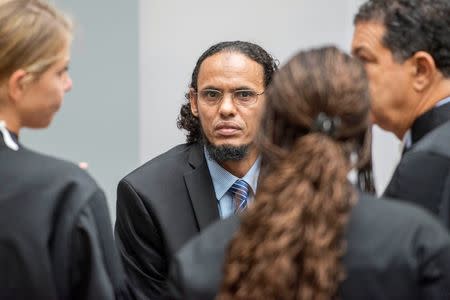 Ahmad al-Faqi al-Mahdi (C) appears at the International Criminal Court in The Hague, Netherlands, August 22, 2016 at the start of his trial on charges of involvement in the destruction of historic mausoleums in Timbuktu during Mali's 2012 conflict. REUTERS/Patrick Post/Pool