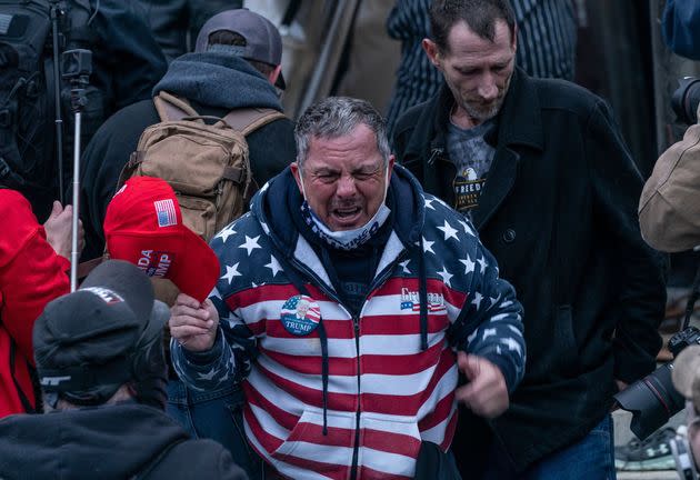 HuffPost identified Robert Scott Palmer (center) as a member of the pro-Trump crowd that stormed the U.S. Capitol on Jan. 6. He was filmed assaulting police with a fire extinguisher. (Photo: Lev Radin/Pacific Press/Shutterstock)