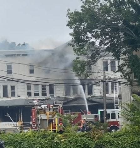 Firefighters battle a three-alarm blaze on Belfield Avenue in Atlantic City on June 21, 2023.
