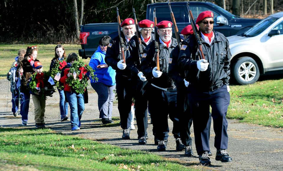 Members of American Legion Post 166 Color Guard lead scout troops through Alliance City Cemetery on Saturday, Dec. 16, 2023, for the placing of Christmas wreaths on veterans graves during the Wreaths Across America ceremony.