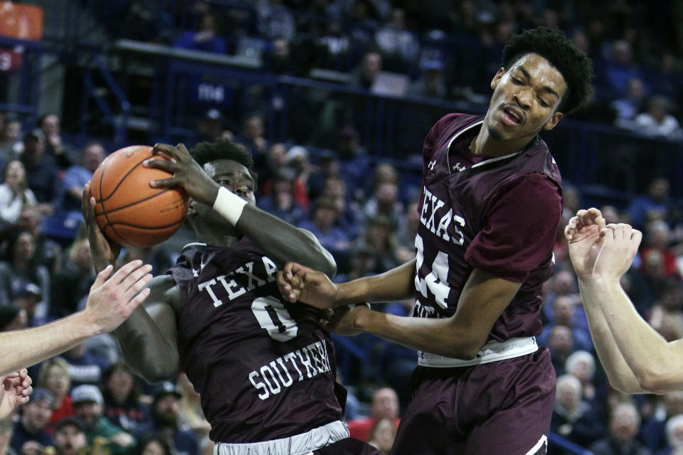 Texas Southern forward Yahuza Rasas (0) grabs a rebound in front of forward John Walker III (24) during the second half of an NCAA college basketball game against Gonzaga in Spokane, Wash., Wednesday, Dec. 4, 2019. Gonzaga won 101-62. (AP Photo/Young Kwak)