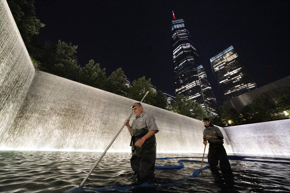 James Maroon, left, cleans the bottom of the south pool of the 9/11 Memorial with a vacuum, Wednesday, Aug. 4, 2021, in New York. On Sept. 11, 2001 he was going to work at the New York Mercantile Exchange, just west of the twin towers. "I was getting ready to cross the Westside Highway when the first plane hit and people were running up behind me," he said. "I thought a truck or something hit the walkway. I got out, looked up and the first plane was in the building. I thought it was just a small commuter plane because you didn't see a plane, just a hole. I ended going into work and then the second plane hit. I couldn't figure out where to go. Pretty much everything was closed off. I hooked up with a guy I worked with and we started walking up the Westside Highway and I looked back and the tower collapsed. Unbelievable." (AP Photo/Mark Lennihan)