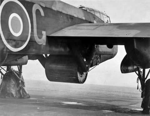 The giant Upkeep bomb under Guy Gibson's Lancaster during trials, May 1943 - Credit: RAF/National Archives