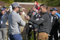 Aaron Rodgers, left, talks with Alex Smith before the start of the putting challenge event of the AT&T Pebble Beach Pro-Am golf tournament in Pebble Beach, Calif., Wednesday, Feb. 1, 2023. (AP Photo/Eric Risberg)