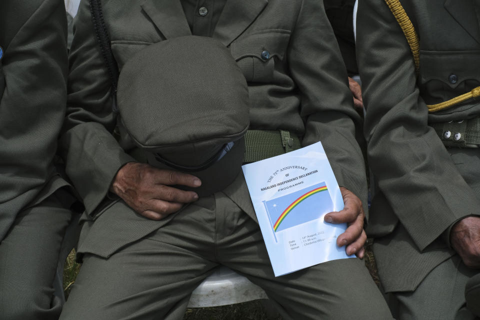 A retired veteran of the Naga Army holds his hat while joining the gathering in prayer during celebrations marking the Nagas' Declaration of Independence in Chedema, in the northeastern Indian state of Nagaland, Sunday, Aug. 14, 2022. The Nagas - an indigenous people inhabiting several northeastern Indian states and across the border in Myanmar - marked the 75th anniversary of their declaration of independence on Sunday. Seeking self-rule, Nagas had announced independence a day ahead of India's in 1947 and mark this moment every year across northeast states where the Naga community live. (AP Photo/Yirmiyan Arthur)