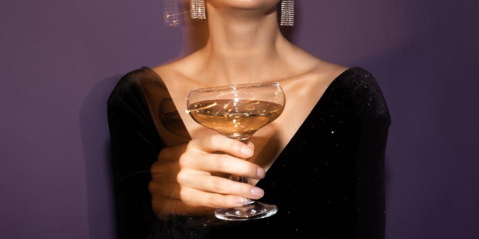 a woman holding a glass of wine