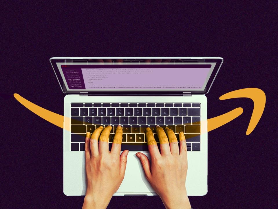 A laptop displaying an open Slack window is shown from a top-down view with a person's hands just visible on the keyboard. The Amazon logo is overlaid, partially transparent, on top of the image.