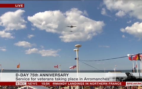 Planes fly over the service in Arromanches - Credit: BBC