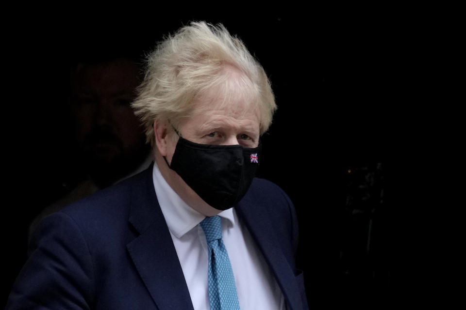 Britain's Prime Minister Boris Johnson leaves 10 Downing Street to attend the weekly Prime Ministers' Questions session in parliament in London, Wednesday, Jan. 26, 2022. Johnson is bracing for the conclusions of an investigation into allegations of lockdown-breaching parties, a document that could help him end weeks of scandal and discontent, or bring his time in office to an abrupt close. (AP Photo/Kirsty Wigglesworth)