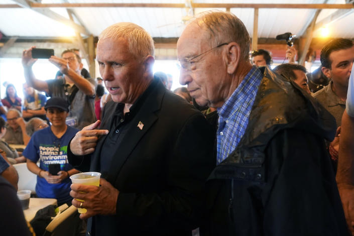 Former Vice President Mike Pence talks with Sen. Chuck Grassley, R-Iowa, during a visit to the Iowa State Fair, Friday, Aug. 19, 2022, in Des Moines, Iowa. (AP Photo/Charlie Neibergall)