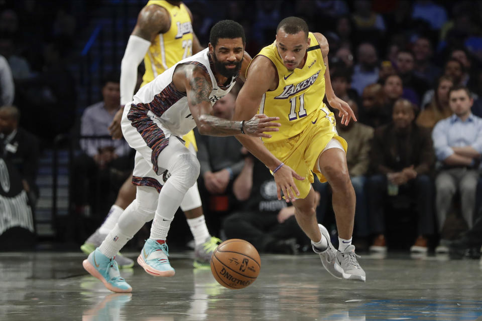 Los Angeles Lakers' Avery Bradley (11) knocks the ball away from Brooklyn Nets' Kyrie Irving (11) during the first half of an NBA basketball game Thursday, Jan. 23, 2020, in New York. (AP Photo/Frank Franklin II)