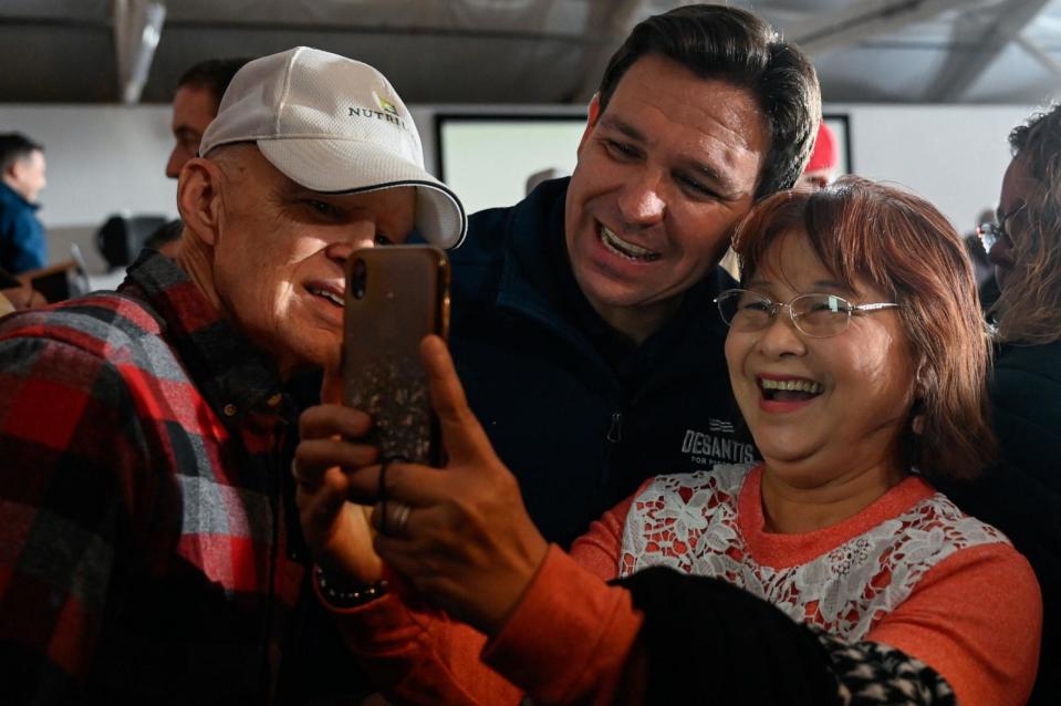 PHOTO: Republican presidential candidate and Florida Governor Ron DeSantis interacts with his supporters at a Never Back Down campaign event at The Thunderdome in Newton, Iowa, Dec. 2, 2023.  (Vincent Alban/Reuters)