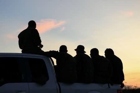 FILE PHOTO - Members of the Bahamian military ride in the back of a truck in the wake of Hurricane Dorian in Marsh Harbour