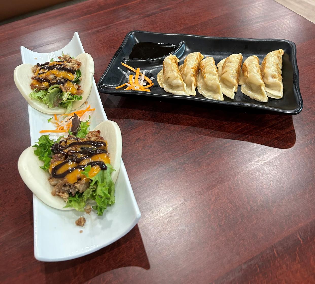 Appetizers at Noodle King include moo shu pork belly buns, at left, and pan-fried gyoza dumplings.