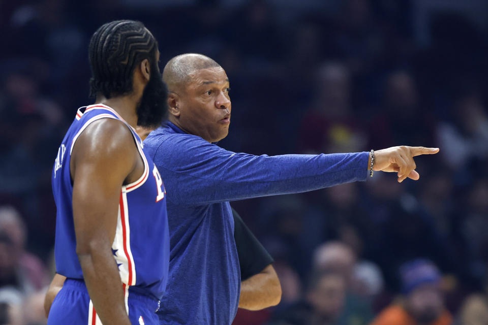 Philadelphia 76ers head coach Doc Rivers talks with 76ers' guard James Harden during the first half of a preseason NBA basketball game, Monday, Oct. 10, 2022, in Cleveland. (AP Photo/Ron Schwane)