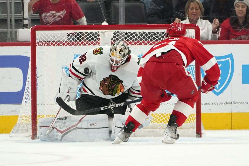 Chicago Blackhawks goaltender Alex Stalock (32) stops a Detroit Red Wings center Dylan Larkin (71) penalty shot in the first period of an NHL hockey game Wednesday, March 8, 2023, in Detroit. (AP Photo/Paul Sancya)