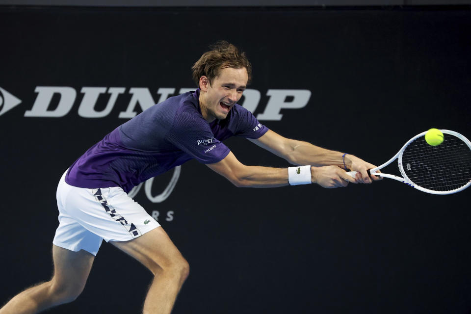 Russia's Daniil Medvedev makes a backhand return to Serbia's Novak Djokovic in the semi final match at the Adelaide International Tennis tournament in Adelaide, Australia, Saturday, Jan. 7, 2023. (AP Photo/Kelly Barnes)