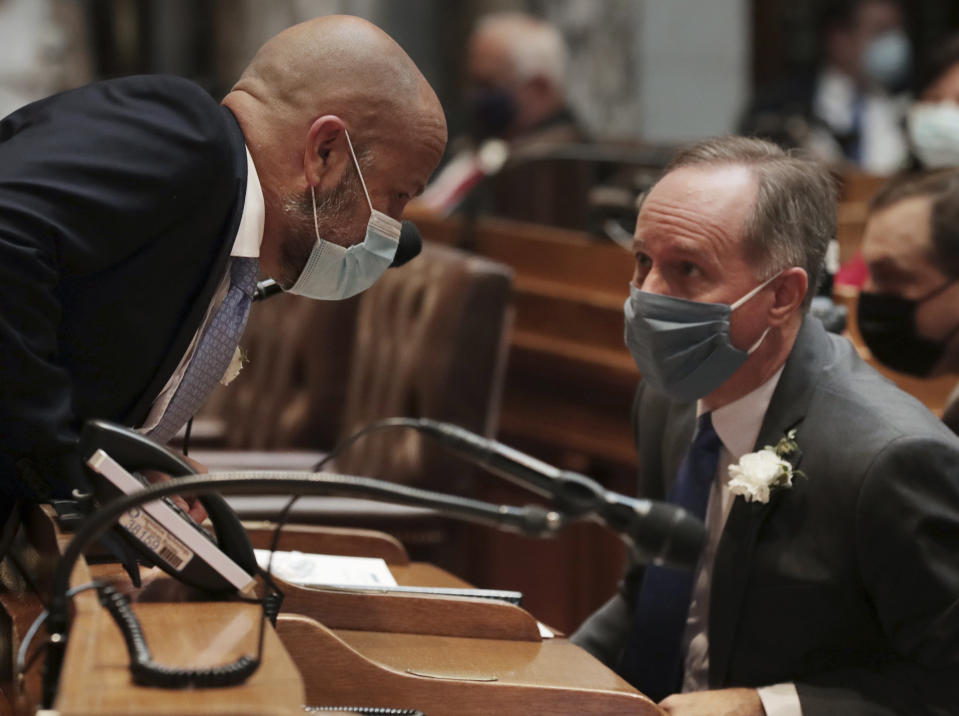 FILE - In this Jan. 4, 2021, file photo, Wisconsin Assembly Majority Leader Jim Steineke, R-Kaukauna, left, talks with Wisconsin Assembly Speaker Robin Vos, R-Rochester, during the first 2021-22 legislative session in the Assembly Chambers at the Wisconsin State Capitol in Madison, Wis. Wisconsin Gov. Tony Evers has issued a new statewide mask order an hour after the Republican-controlled Legislature voted to repeal his previous mandate on Thursday, Feb. 4, 2021. The Democrat Evers said in a video message Thursday that his priority is keeping people safe and that wearing a mask was the most basic way to do that. (Amber Arnold/Wisconsin State Journal via AP, File)