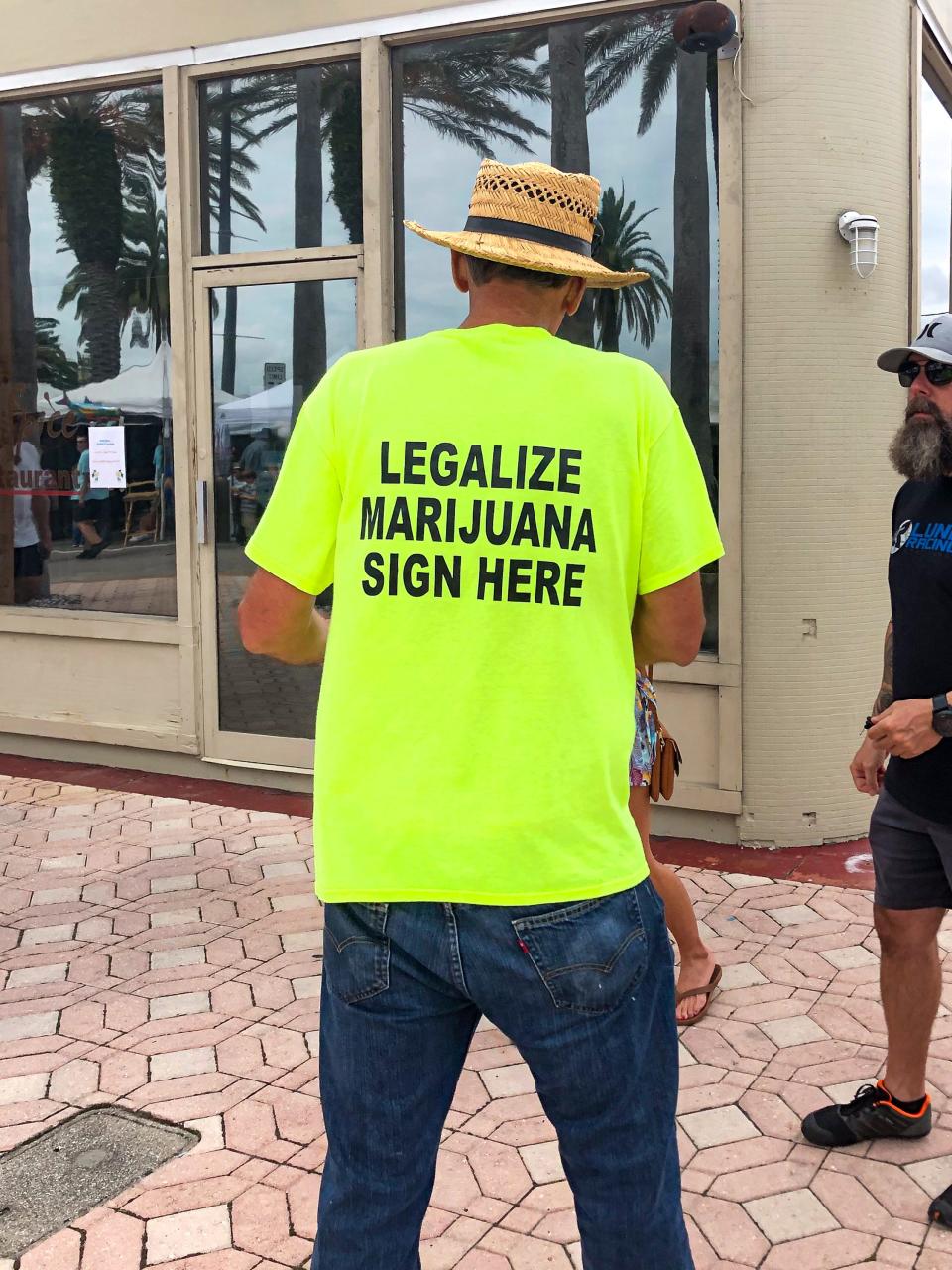 A man gathers signatures for the recreational marijuana amendment in Daytona Beach July, 2023.