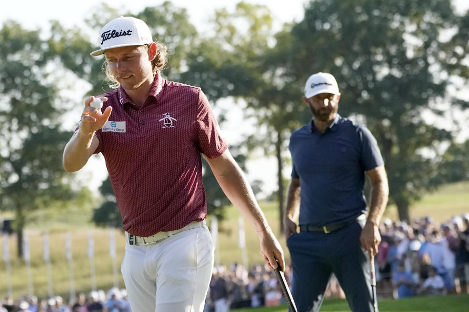 Cameron Smith acknowledges the crowd's applause after wining the LIV Golf Invitational-Chicago tournament over Dustin Johnson, right, and Peter Uihlein, Sunday, Sept. 18, 2022, in Sugar Hill, Ill. (AP Photo/Charles Rex Arbogast)