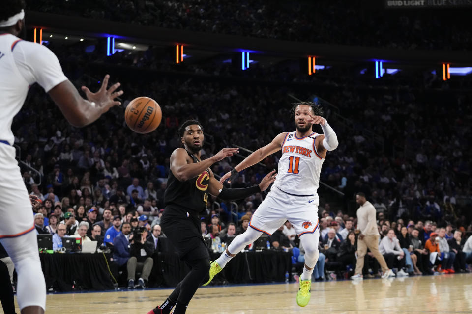 New York Knicks' Jalen Brunson (11) passes the ball away from Cleveland Cavaliers' Donovan Mitchell (45) during the second half of Game 3 in an NBA basketball first-round playoff series Friday, April 21, 2023, in New York. The Knicks won 99-79. (AP Photo/Frank Franklin II)