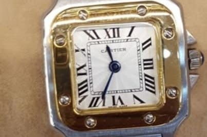 Stolen: a Cartier watch is among the valuable items taken in three raids on homes in the Enfield area: Metropolitan Police