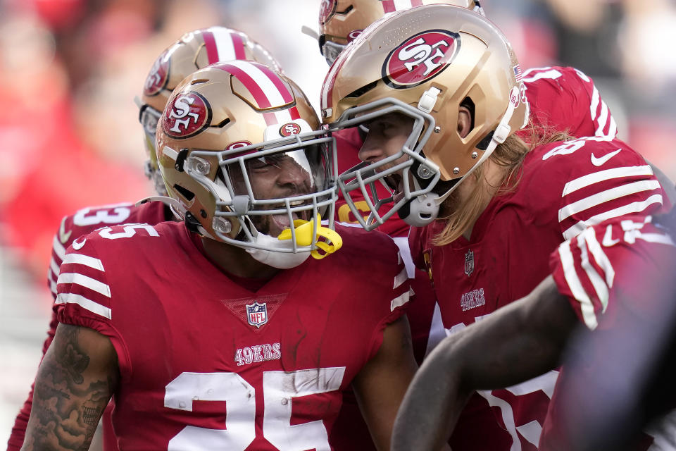 San Francisco 49ers running back Elijah Mitchell, left, celebrates with tight end George Kittle after scoring against the Arizona Cardinals during the first half of an NFL football game in Santa Clara, Calif., Sunday, Jan. 8, 2023. (AP Photo/Godofredo A. Vásquez)