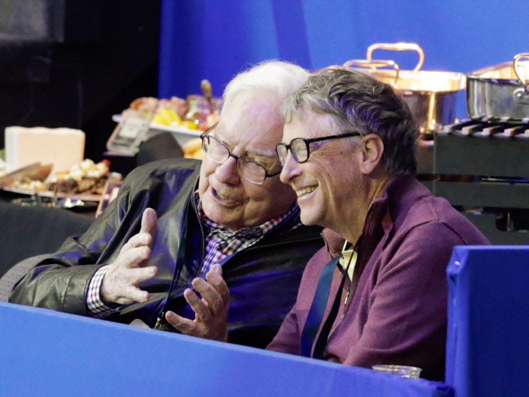 Bill Gates, right, and Warren Buffett talk during a break in the FEI World Cup equestrian jumping grand prix in Omaha, Neb., Saturday, April 1, 2017. Jennifer Gates, daughter of Bill Gates, is one of the contestants.