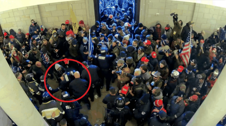 Salvador Sandoval Jr., in the grey hood, is allegedly seen grappling with police officers during the Jan. 6 invasion of the U.S. Capitol building in this surveillance video image filed in court.