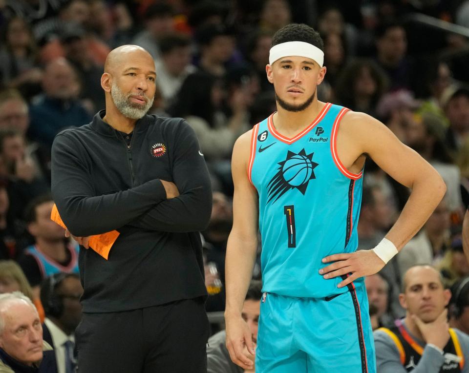 Phoenix Suns head coach Monty Williams talks with guard Devin Booker (1) during the second quarter against the San Antonio Spurs at Footprint Center in Phoenix on April 4, 2023.