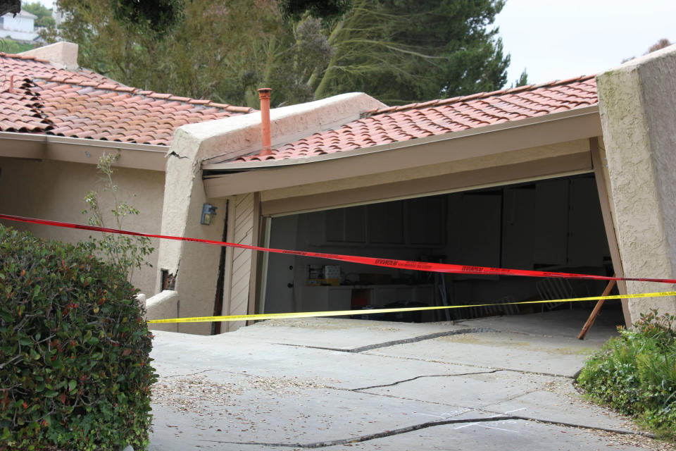 A house in Rolling Hills Estates is severely damaged after a landslide on the Palos Verdes Peninsula in Los Angeles County early Sunday, July 9, 2023. Multiple homes were evacuated in the Los Angeles-area city after a major ground shift put them at risk of collapse, officials said Sunday. (Michael Hixon/The Orange County Register via AP)