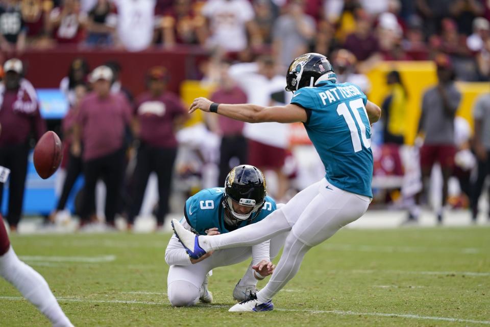 Jacksonville Jaguars place kicker Riley Patterson (10) kicking a field goal against the Washington Commanders during the second half of an NFL football game, Sunday, Sept. 11, 2022, in Landover, Md. Holding the ball was Jacksonville Jaguars punter Logan Cooke (9). (AP Photo/Alex Brandon)